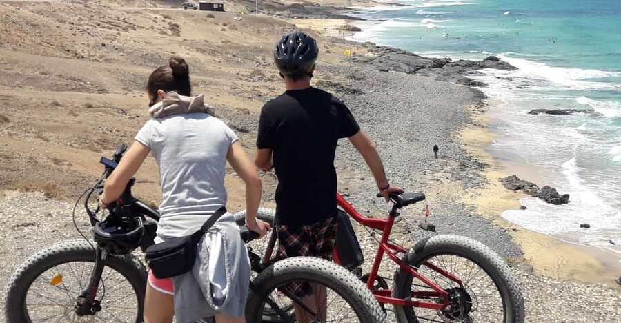 Caleta de Fuste/Corralejo: Guided E-Bike Tour & Crater Hike - Getting there: pickup, coach transfer, and the small-group rhythm
