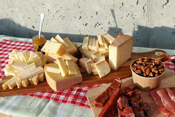 Cheese and chocolate on mountain summit - Cold cuts, bread or crackers, and jam to balance the bite